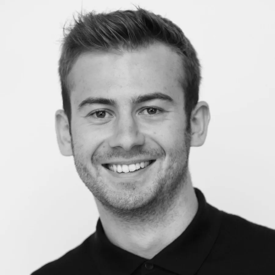 Dylan Winn-Brown, founder of SpaceWorks, smiling in a black polo shirt