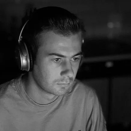 Dylan Winn-Brown of SpaceWorks working at a screen wearing headphones
