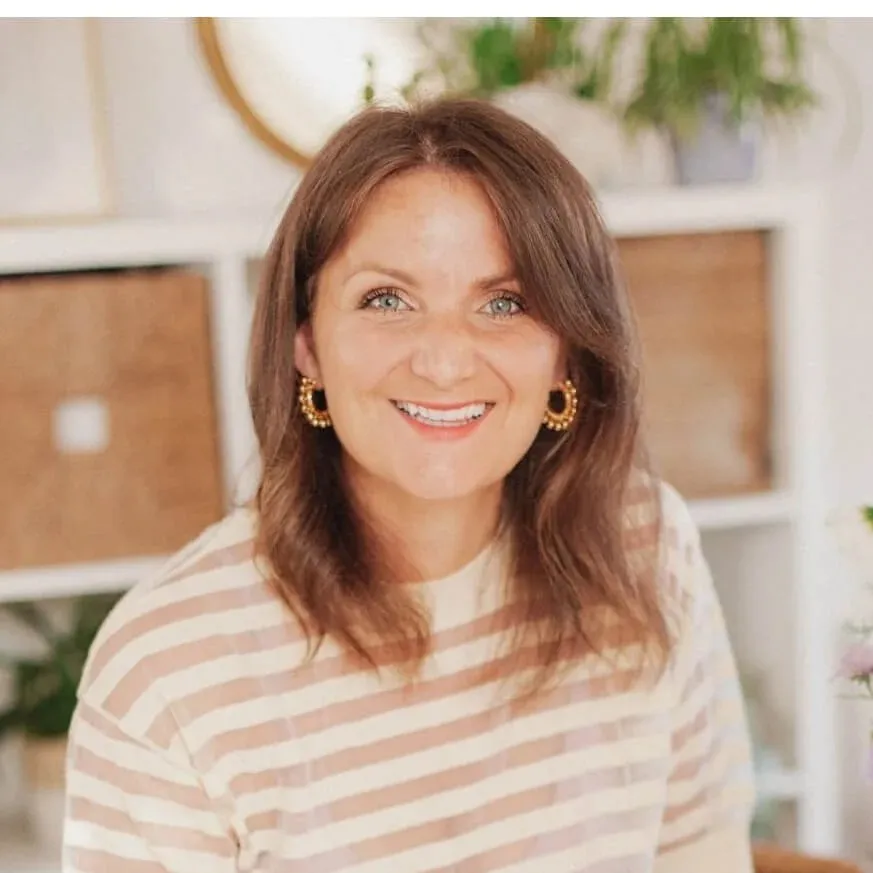 Elizabeth Ellery, Squarespace website designer in the Cotswolds, smiling at her desk