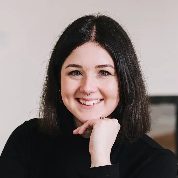 Emily Lewis, founder of TwoFold, seated in an office and smiling
